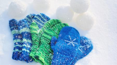 mittens blue and green mittens on snow