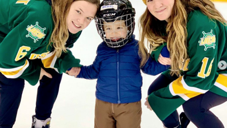 Skate with the Lakers Two women hockey players with a toddler wearing hockey gear