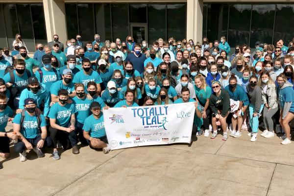 Group of people wearing teal