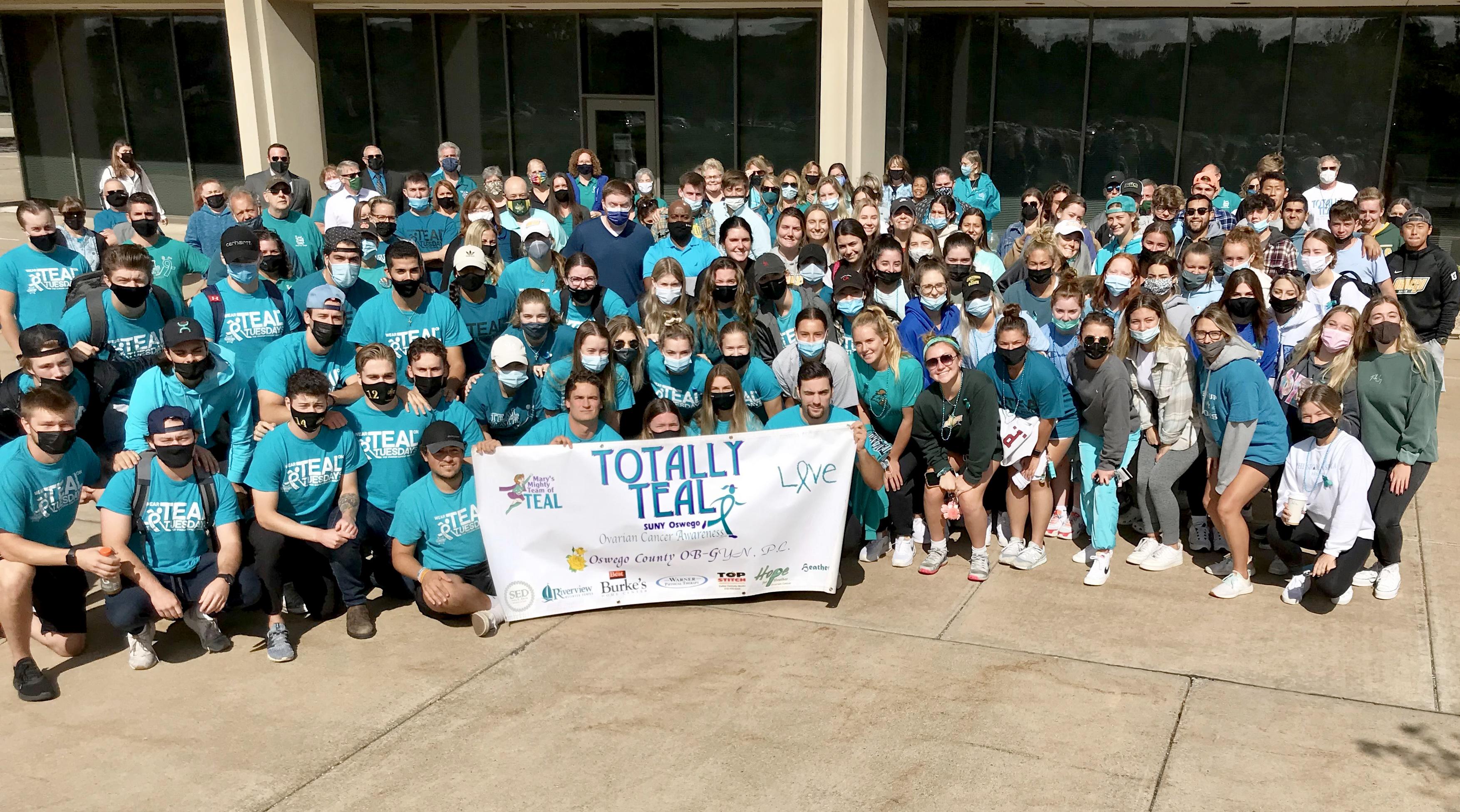 Group of people wearing teal