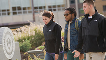 Three students walk across campus (deja vu!)