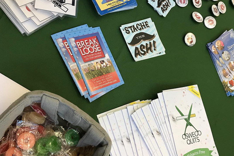 Table filled with pamphlets and stickers about kick butts day
