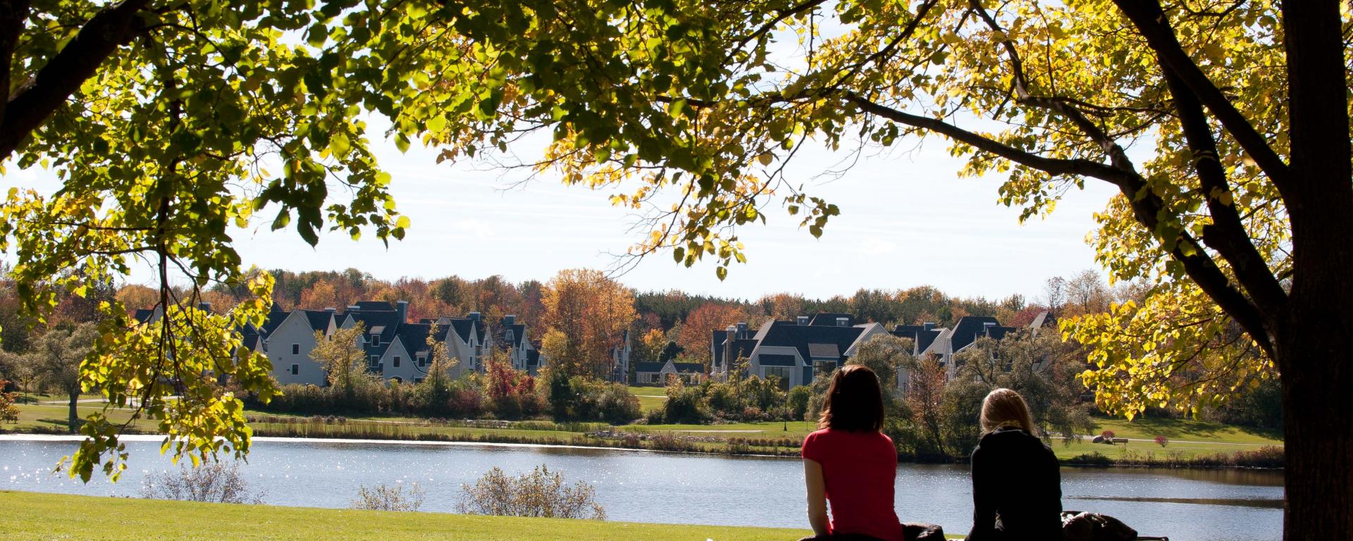 Landscape with two students looking towards the village on a sunny day