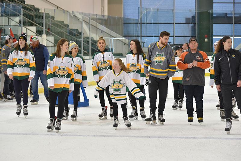 Oswego State Lakers Ice Skating with young ice skaters