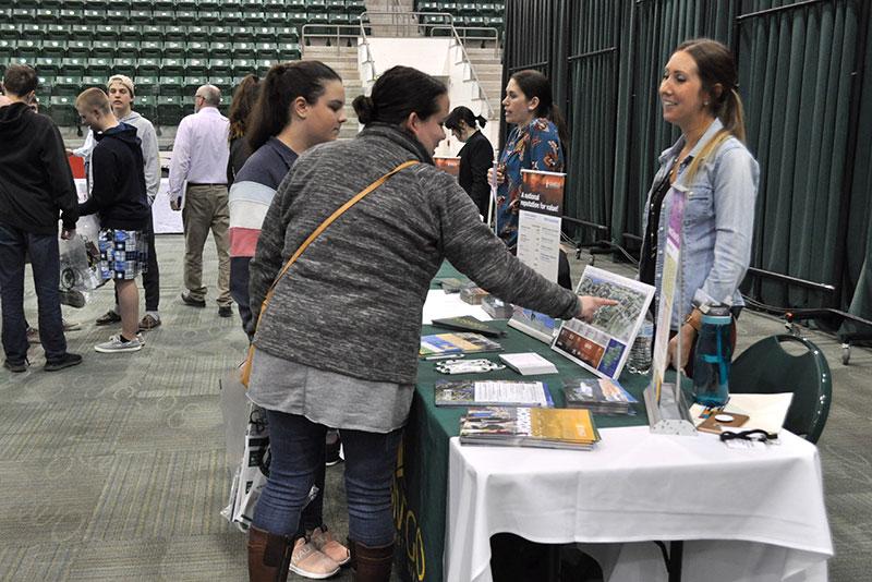 Students speaking with a vendor in career day