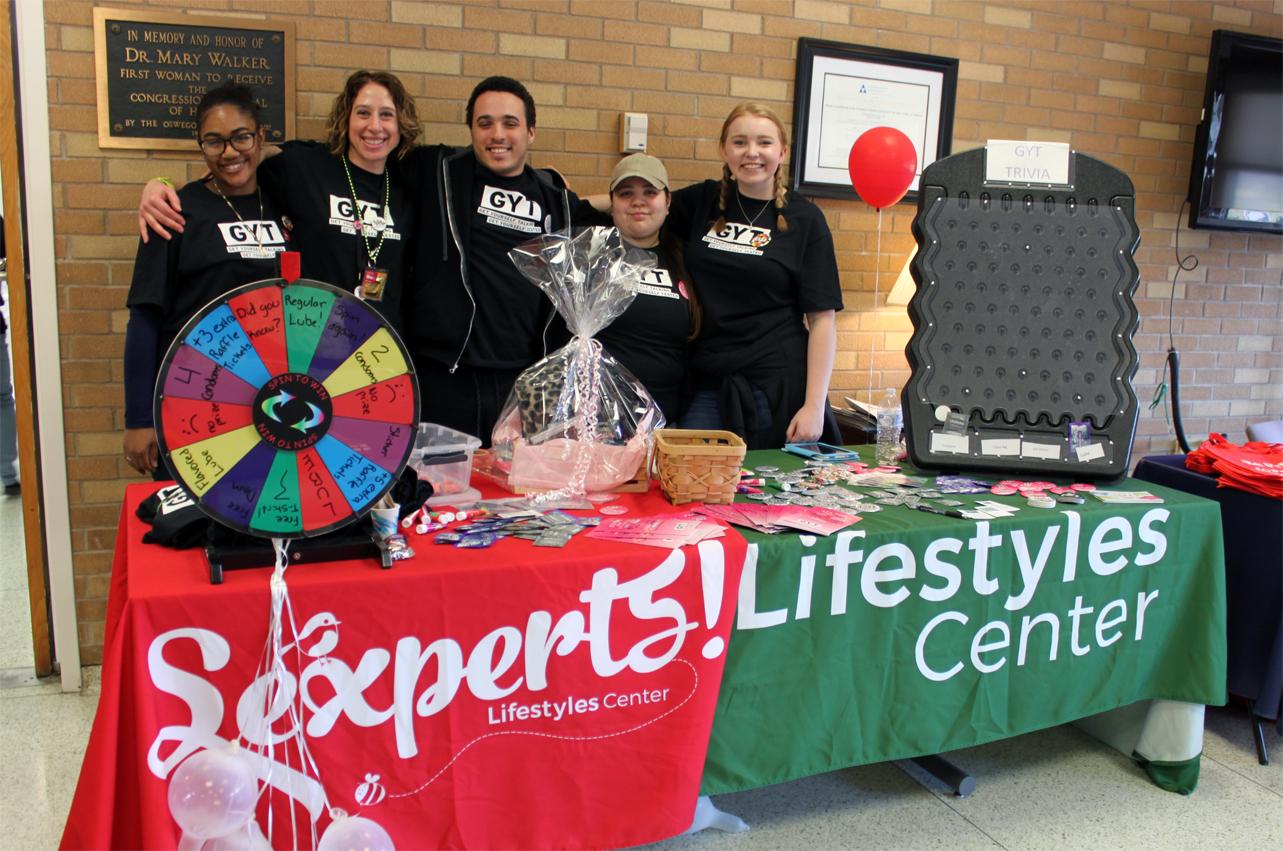 Angie Brown standing with two student groups during Get Yourself Tested