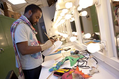 Student painting masks in the Make Up Runway